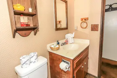 a bathroom with a sink and a toilet at Gallagher's West - Pine surrounded deck and barbecue! Bumper Pool and Wet bar! Darts! in Big Bear Lake