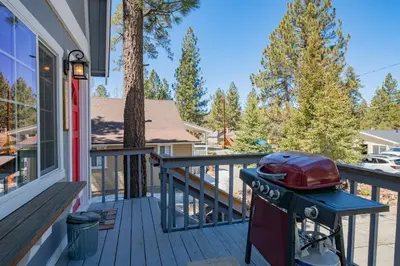 a grill on a porch of a house at Glenview Getaway - Cozy farm house! Walking distance to the lake! in Big Bear Lake