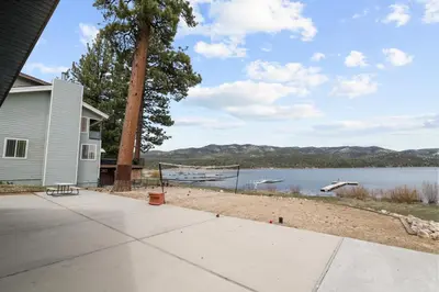 a house with a view of a lake at Hakuna Matata Lakefront - LAKEFRONT, PRIVATE DOCK, AND GAME ROOM! in Big Bear Lake