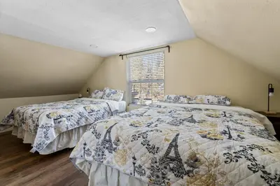 a bedroom with two beds and a window at Jaybird Lodge - Large and spacious home near the Lake and Village! in Big Bear Lake