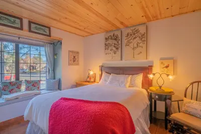 a bedroom with a large bed and a window at Junipine Lakefront Condo - Walking distance to the lake! Less than 2 miles from the slopes! in Big Bear Lake