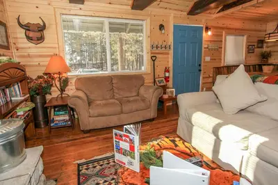 a living room with a couch and a chair at Knotty Knight- Walking distance to the lake as well as the Village! in Big Bear Lake