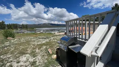 a barbecue grill sitting on the side of a house at Lakefront Oasis - Adorable lakefront cabin with a private beach! in Big Bear Lake