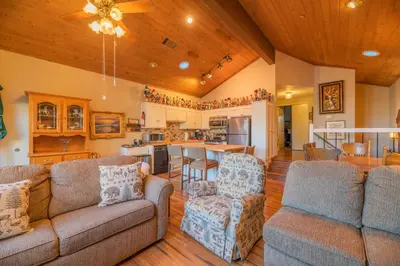 a living room with two couches and a kitchen at Lakefront Viking Oasis - Beautiful Viking Estates condo complex on the lake! in Big Bear Lake