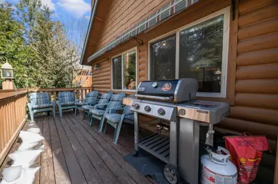 a grill on the deck of a house at Treetop Bearadise - Best mountain living in a nicely furnished and decorated home in Big Bear Lake