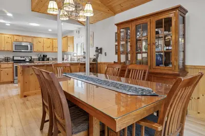 a kitchen with a large wooden table and chairs at Treetop Bearadise - Best mountain living in a nicely furnished and decorated home in Big Bear Lake