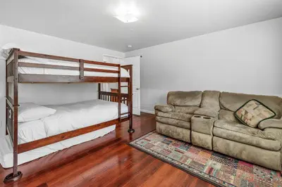 a living room with a bunk bed and a couch at The Rock House - Walk to Big Bear Snow Play! Walk to Oktoberfest! Perfect weekend getaway! in Big Bear City