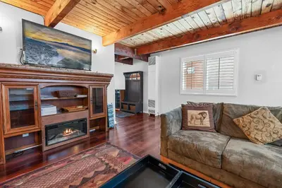 a living room with a couch and a fireplace at The Rock House - Walk to Big Bear Snow Play! Walk to Oktoberfest! Perfect weekend getaway! in Big Bear City