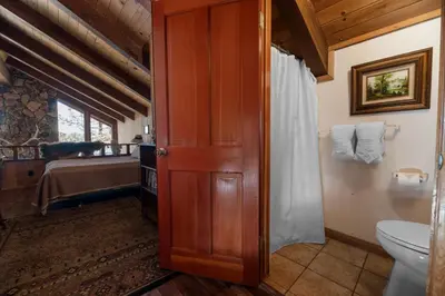 a bathroom with a toilet and a sink at The Voges' Lake House - Amazing lake front house with a beautiful view and game room! in Big Bear Lake
