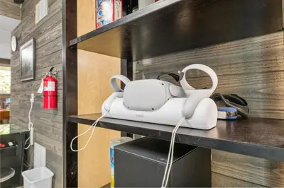 a white machine sitting on a table in a room at The Grizzlies Den - Log style cabin located in the desirable Fox Farm area! Games and arcade! in Big Bear Lake
