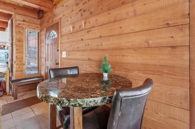 a wooden dining room with a table and chairs at The Lakehouse Cabin - Located close to the Lake! Hot Tub, Smart TV, and WiFi! in Big Bear Lake