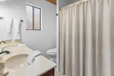 a bathroom with a sink and a toilet and a shower at The Lakehouse Cabin - Located close to the Lake! Hot Tub, Smart TV, and WiFi! in Big Bear Lake