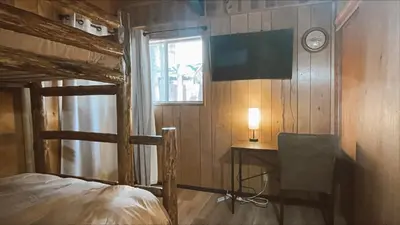 a bedroom with a desk and a bed and a window at The Oasis Chalet - Walking distance to The Village, The Lake, and Alpine Slide! in Big Bear Lake