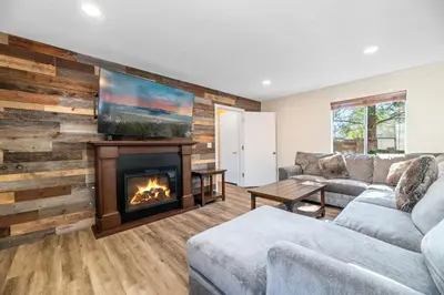 a living room with a couch and a fireplace at The Bear Den - DREAM LOCATION WALKING DISTANCE TO LAKE AND VILLAGE! in Big Bear Lake