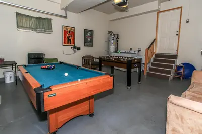 a living room with a pool table and a stairway at The Fox Paw - Cozy and spacious cabin! Family game room with Foosball and Pool Table! Jet Tub! in Big Bear Lake