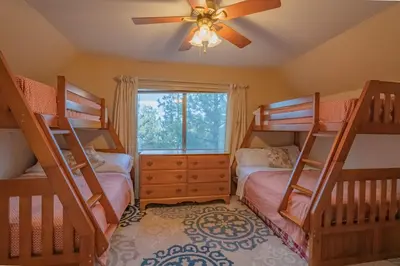 a bedroom with two bunk beds and a ceiling fan at Sweet Retreat - Spectacular little hideaway, cozy family getaway near the lake! in Big Bear Lake
