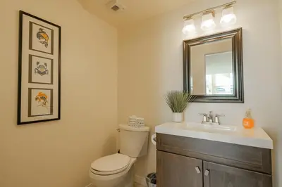 a bathroom with a toilet and a sink and a mirror at Modern Times - Amazing place with super open concept! Jet tub! in Big Bear Lake