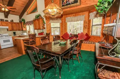 a dining room and kitchen with a table and chairs at Summit Adventure - Beautiful, spacious and quiet home! Foosball, pool and poker table! Jet tub! in Big Bear Lake