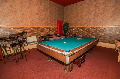 a room with a pool table and a bar at Summit Adventure - Beautiful, spacious and quiet home! Foosball, pool and poker table! Jet tub! in Big Bear Lake
