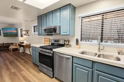a kitchen with blue cabinets and a sink at Badger Den - Located in the heart of the village in Big Bear Lake