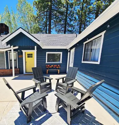 a group of chairs sitting outside of a blue house at Badger Den - Located in the heart of the village in Big Bear Lake