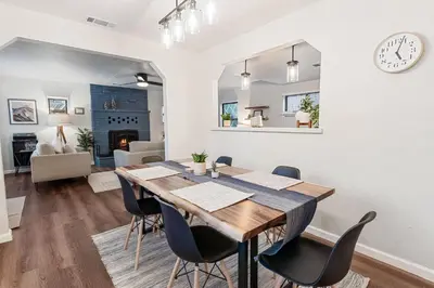 a dining room and living room with a table and chairs at Badger Den - Located in the heart of the village in Big Bear Lake