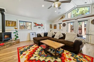 a living room with a couch and a table at Summit Mountain Lodge - Amazing location just down the street from Snow Summit! in Big Bear Lake