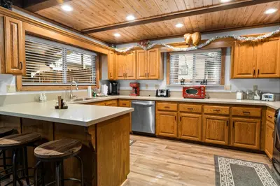 a kitchen with wooden cabinets and a counter top at Summit Mountain Lodge - Amazing location just down the street from Snow Summit! in Big Bear Lake