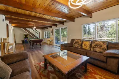 a living room with a couch and a table at Bare Necessities - Comes with a hot tub and a pool table in Big Bear Lake