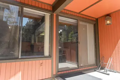 two windows on the side of a building at Ski-In Ski-Out Summit Townhouse- Perfect mountain getaway with views of the forest and Snow Summit! in Big Bear Lake
