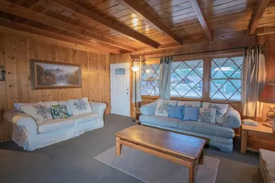 a living room with two couches and a coffee table at Sauer Suite - Cozy, rustic cabin walking distance to Holloway's Marina with peek-a-boo lake views! in Big Bear Lake