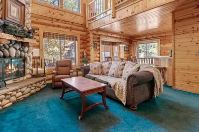 a living room with a couch and a fireplace at Papa Bear's Hideout - Dream Getaway with Hot Tub and Game Room! in Big Bear Lake