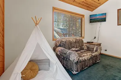 a living room with a tent and a couch at Papa Bear's Hideout - Dream Getaway with Hot Tub and Game Room! in Big Bear Lake