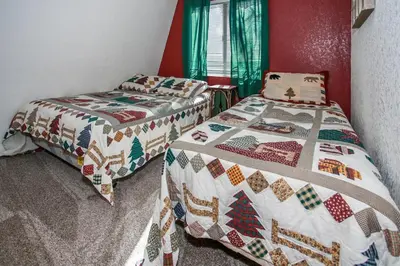 two beds sitting next to each other in a bedroom at Bear 'n Tree - Cozy cabin near the Village in Big Bear Lake