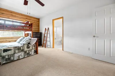 a bedroom with a bed and a window and a door at Bear Bait - Lots of games, televisions, beds, telescope, and 3 bathrooms in Big Bear Lake