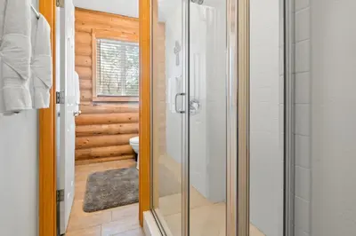 a bathroom with a glass shower and a toilet at Bear Bait - Lots of games, televisions, beds, telescope, and 3 bathrooms in Big Bear Lake