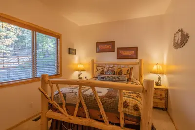 a bedroom with a bed and a window at Bearfoot Bungalow - Premium and spacious home close to the National Forest and The Village! in Big Bear Lake
