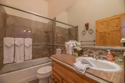 a bathroom with a sink and a shower and a toilet at Bearfoot Bungalow - Premium and spacious home close to the National Forest and The Village! in Big Bear Lake