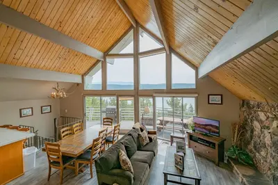 a large living room with a large glass ceiling at Best View - Spacious home with game room, and 180 degree panoramic view of Big Bear Lake! in Fawnskin