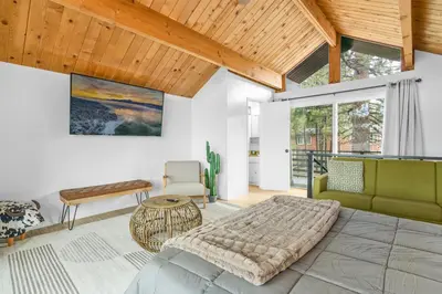 a bedroom with a large bed and a couch at Big Bear Lake View - By far the best location Big Bear, walk to Lake! in Big Bear Lake
