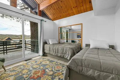 a bedroom with two beds and a balcony at Big Bear Lake View - By far the best location Big Bear, walk to Lake! in Big Bear Lake
