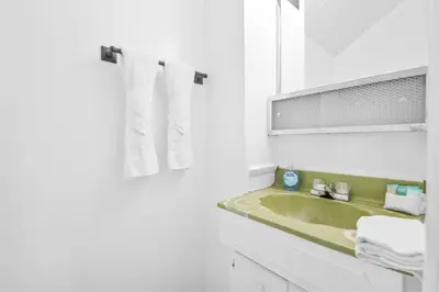 a white bathroom with a sink and a mirror at Big Bear Lake View - By far the best location Big Bear, walk to Lake! in Big Bear Lake