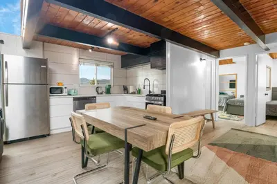 a kitchen and dining room with a wooden table and chairs at Big Bear Lake View - By far the best location Big Bear, walk to Lake! in Big Bear Lake