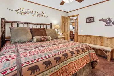 a bedroom with a bed and a wooden bed frame at Blue Jay Chalet - Classic mountain cabin in one of Big Bear's quietest neighborhoods! in Big Bear Lake