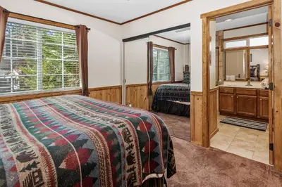 a bedroom with a bed and a mirror at Blue Jay Chalet - Classic mountain cabin in one of Big Bear's quietest neighborhoods! in Big Bear Lake