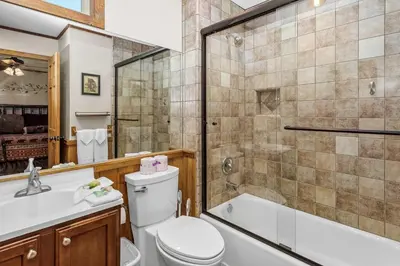 a bathroom with a toilet and a tub and a sink at Blue Jay Chalet - Classic mountain cabin in one of Big Bear's quietest neighborhoods! in Big Bear Lake