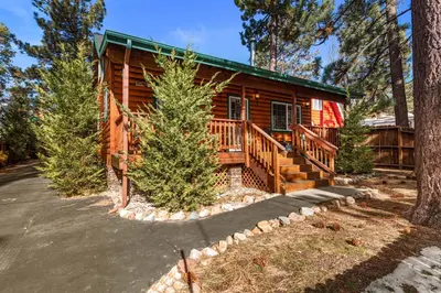 a log cabin with a porch and a driveway at Blue Jay Chalet - Classic mountain cabin in one of Big Bear's quietest neighborhoods! in Big Bear Lake