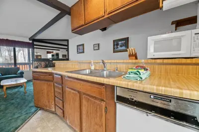 a kitchen with a sink and a microwave at Boulder Bay Chalet Condo - Mountain charm condo with lake view and WIFI! in Big Bear Lake