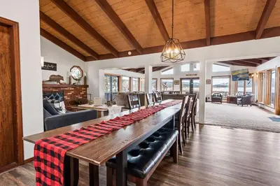 a large dining room with a long table and chairs at Grand Lakefront Escape - Gorgeous Lakefront home with Hot Tub and Game Room! in Big Bear Lake