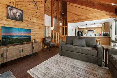 a living room with a couch and a flat screen tv at Hidden Spot - Desirable Fox Farm area of Big Bear in Big Bear Lake